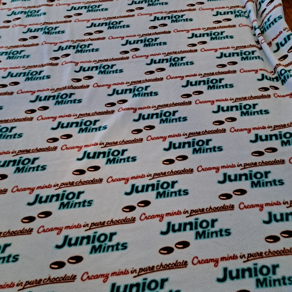 VinTage,Junior Mints Print Fleece Throw in White with Teal and Brown Logo